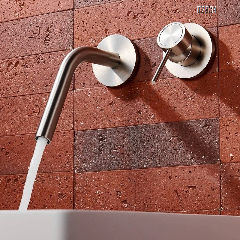 Wall-mounted brass double-handle wash basin faucet for home use with cold and hot water built into the wall of the bathroom